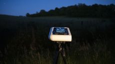 Vaonis Hestia smart telescope on a tripod pointing up at the night sky with a Google Pixel phone attached